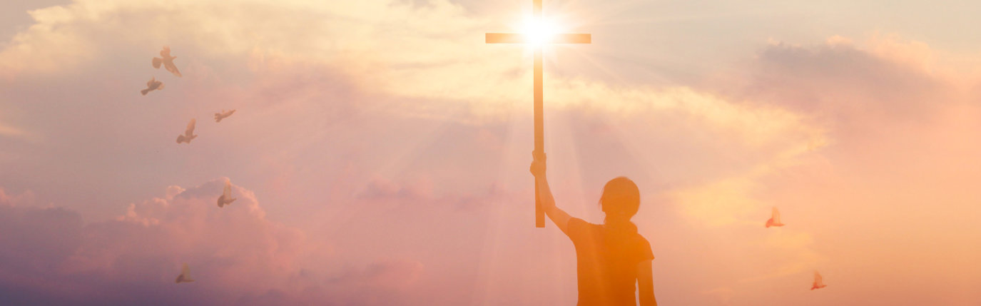 a person holding a cross