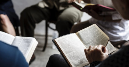 group of people reading bible