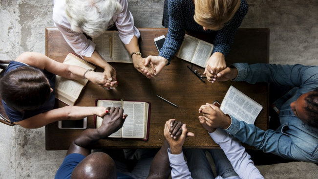 group of people praying together