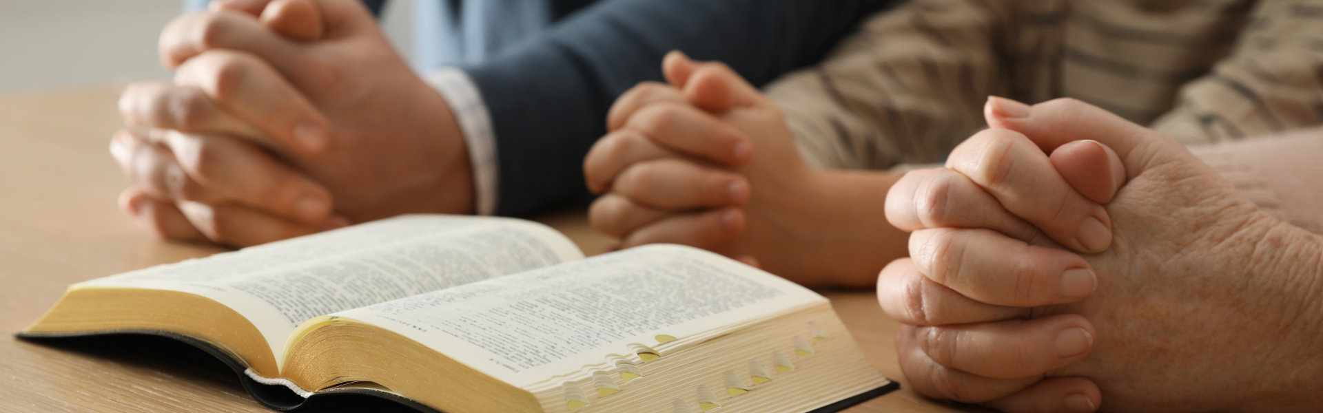 three person praying together