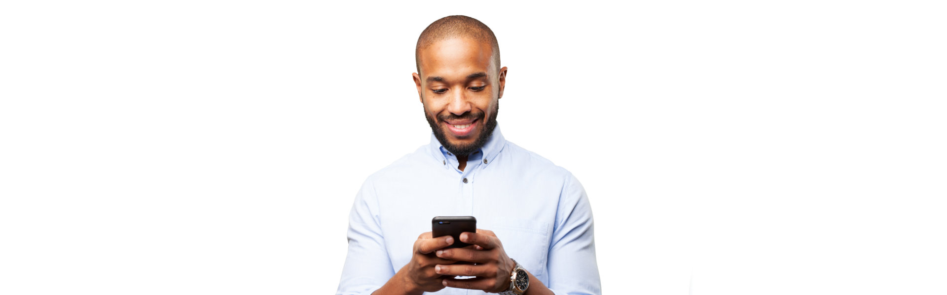 a man smiling while using his phone