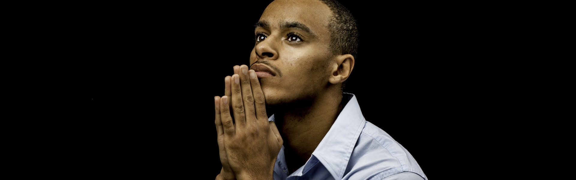 a man looking above and praying